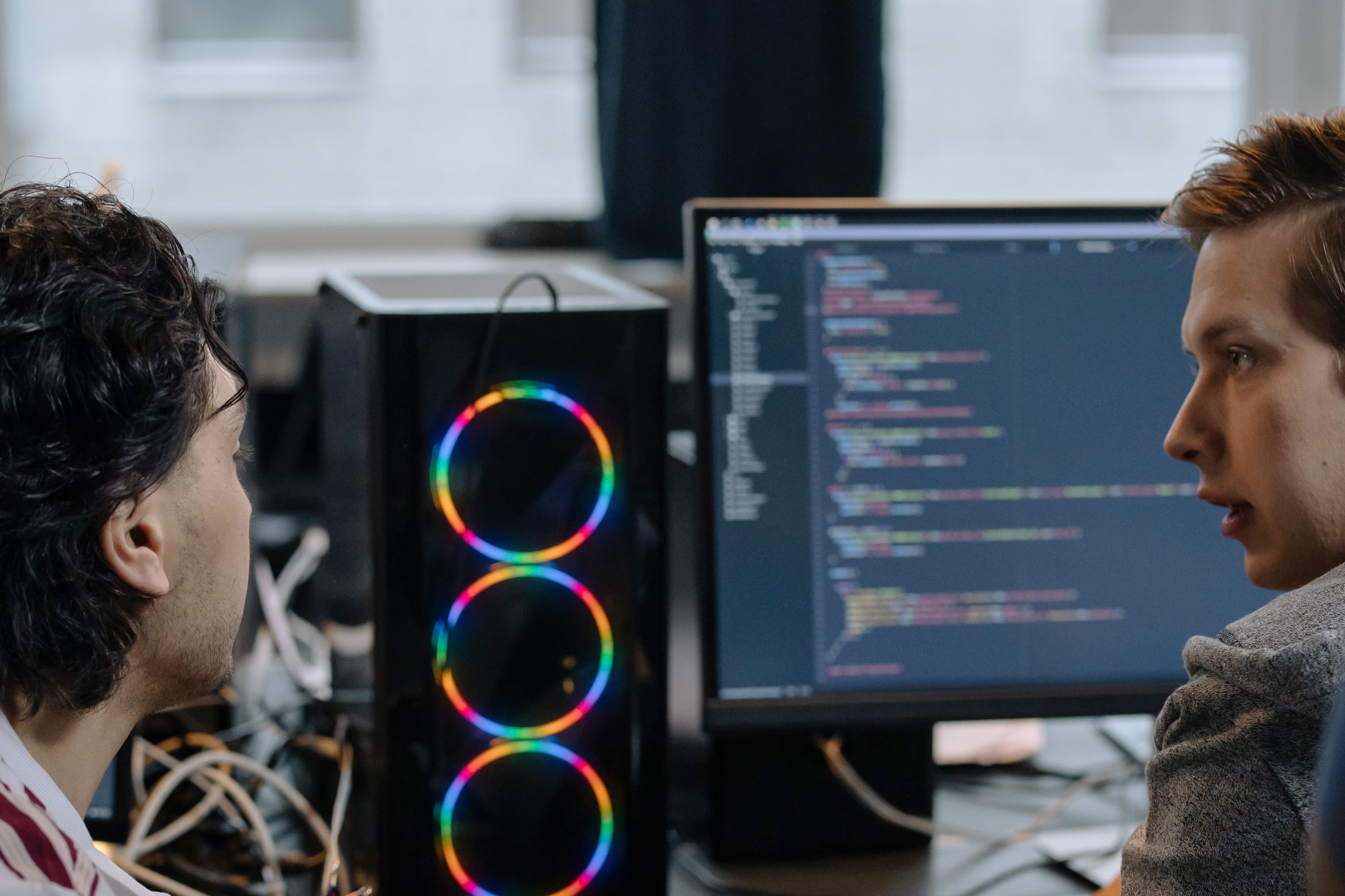 Developers reviewing software on multiple monitors
