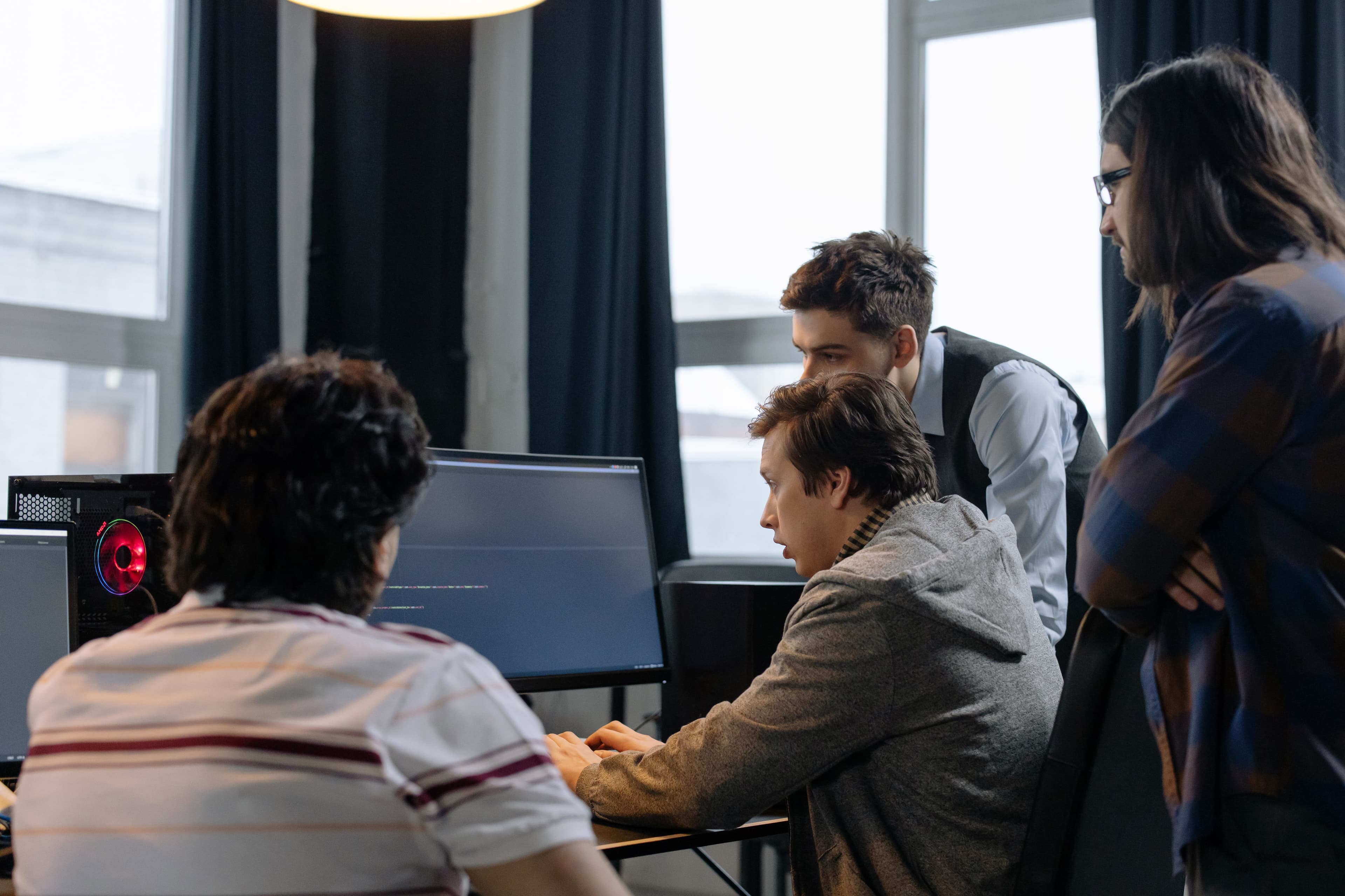 Software engineers collaborating around development workstations